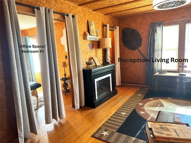 a living room with furniture a fireplace and a floor to ceiling window