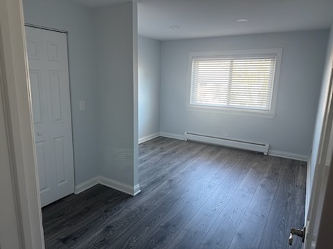 239 North Mill Road, Unit 310 Addison, IL 60101 - Photo 11 of 23 an empty room with wooden floor and windows