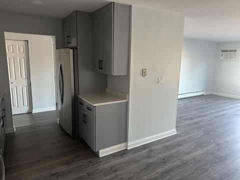 239 North Mill Road, Unit 310 Addison, IL 60101 - Photo 14 of 23 an empty room with wooden floor and a refrigerator