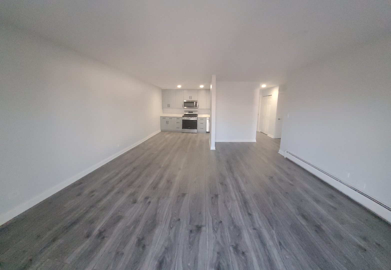 239 North Mill Road, Unit 310 Addison, IL 60101 - Photo 16 of 23 a view of a big room with wooden floor and windows