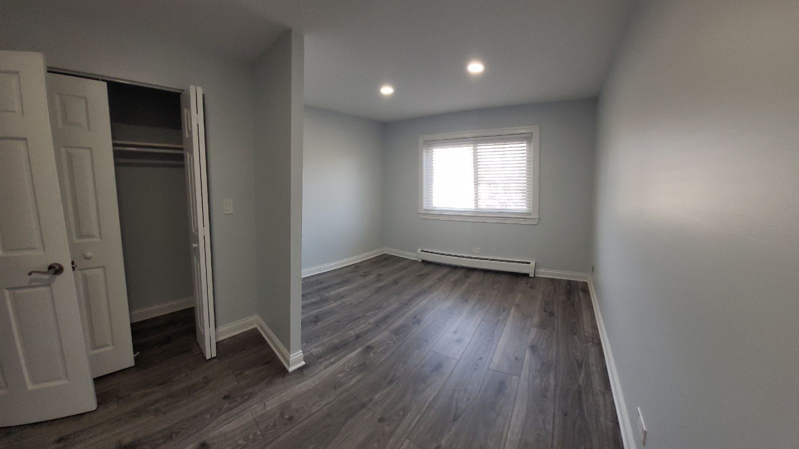 239 North Mill Road, Unit 310 Addison, IL 60101 - Photo 17 of 23 an empty room with wooden floor and windows