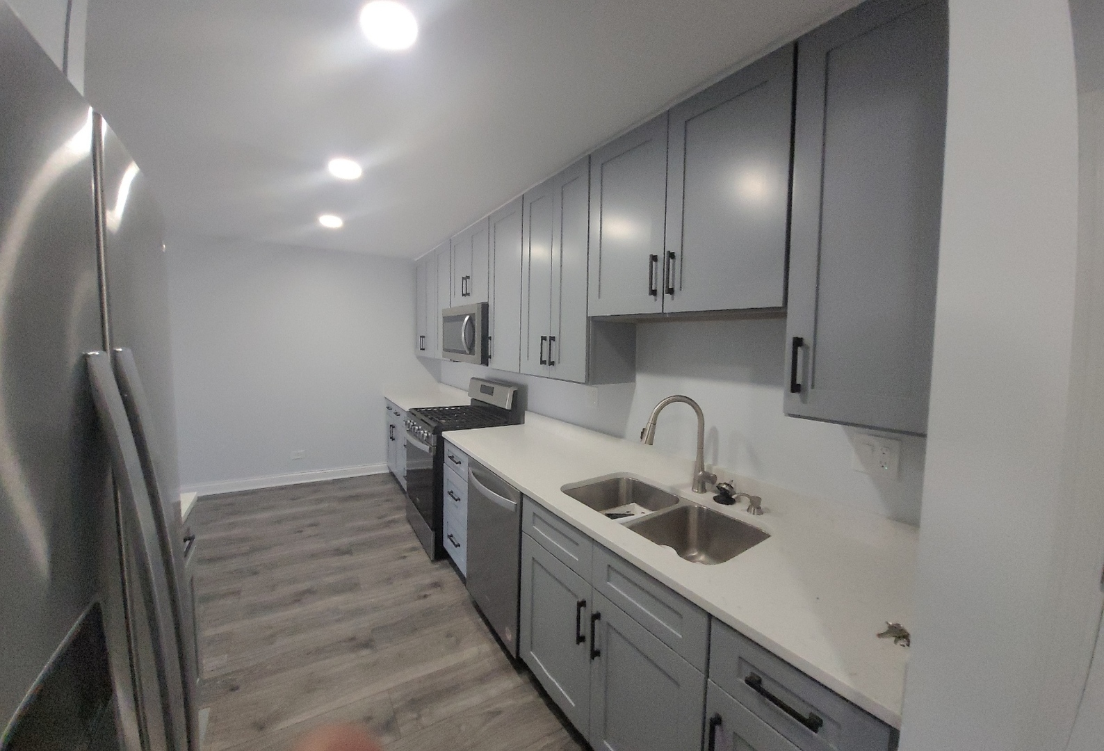 239 North Mill Road, Unit 310 Addison, IL 60101 - Photo 5 of 23 a kitchen with stainless steel appliances granite countertop a sink stove and refrigerator