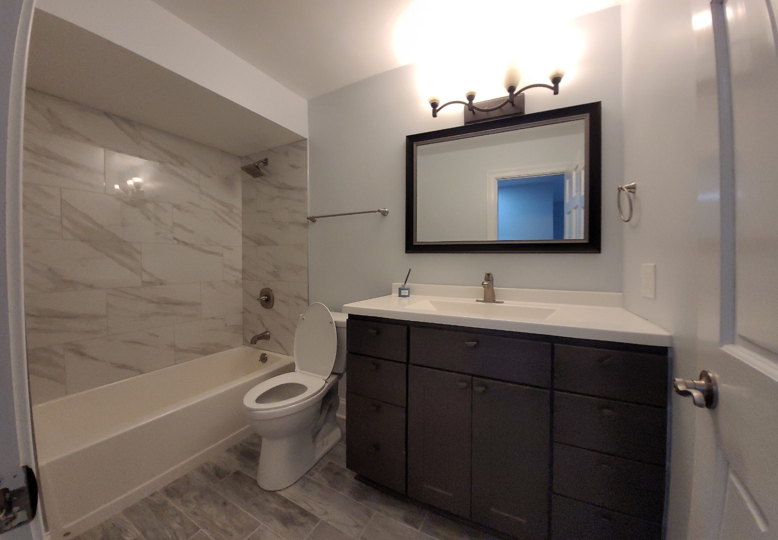 239 North Mill Road, Unit 310 Addison, IL 60101 - Photo 8 of 23 a bathroom with a toilet sink and bathtub