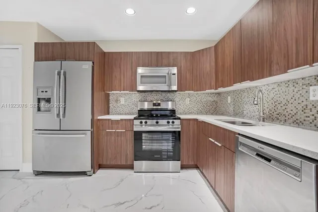 a kitchen with cabinets and a stove top oven
