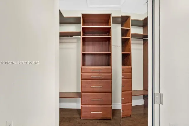 a view of walk in closet with empty racks