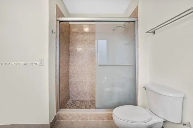 a bathroom with a shower a toilet and a sink