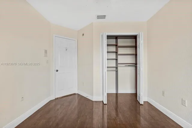 an empty room with wooden floor