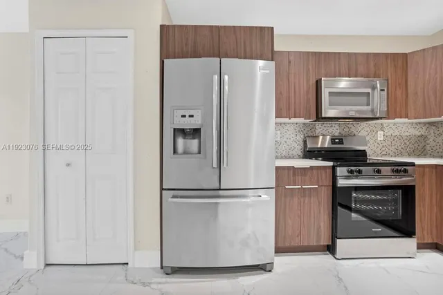 a kitchen with cabinets a refrigerator and a sink