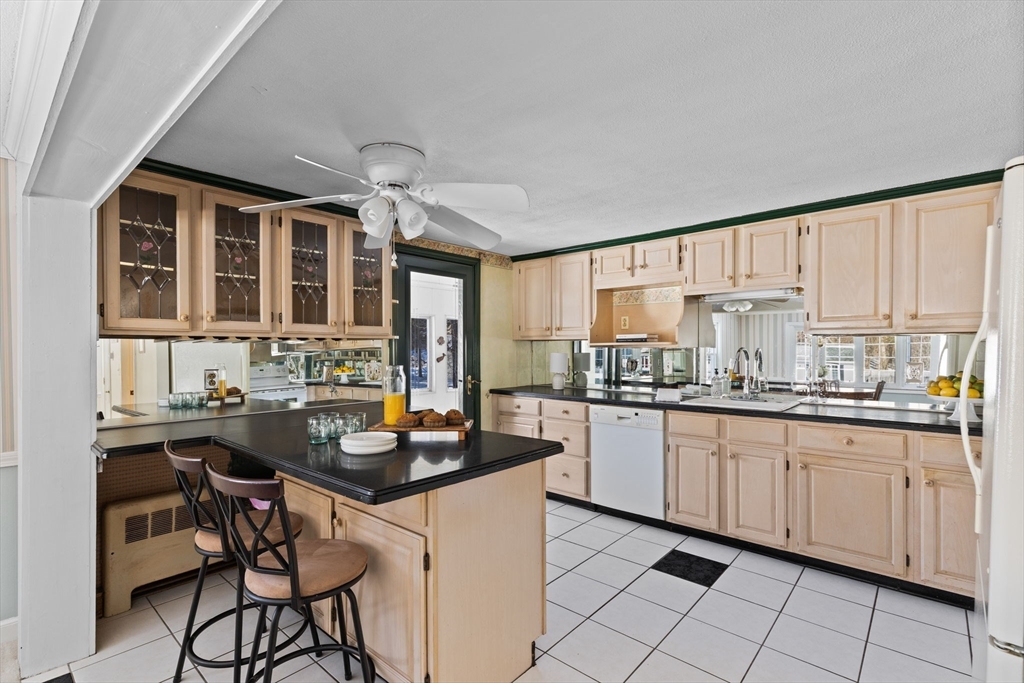39 MacDonald Circle Walpole, MA 02081 - Photo 13 of 38 a kitchen with granite countertop a sink and white cabinets