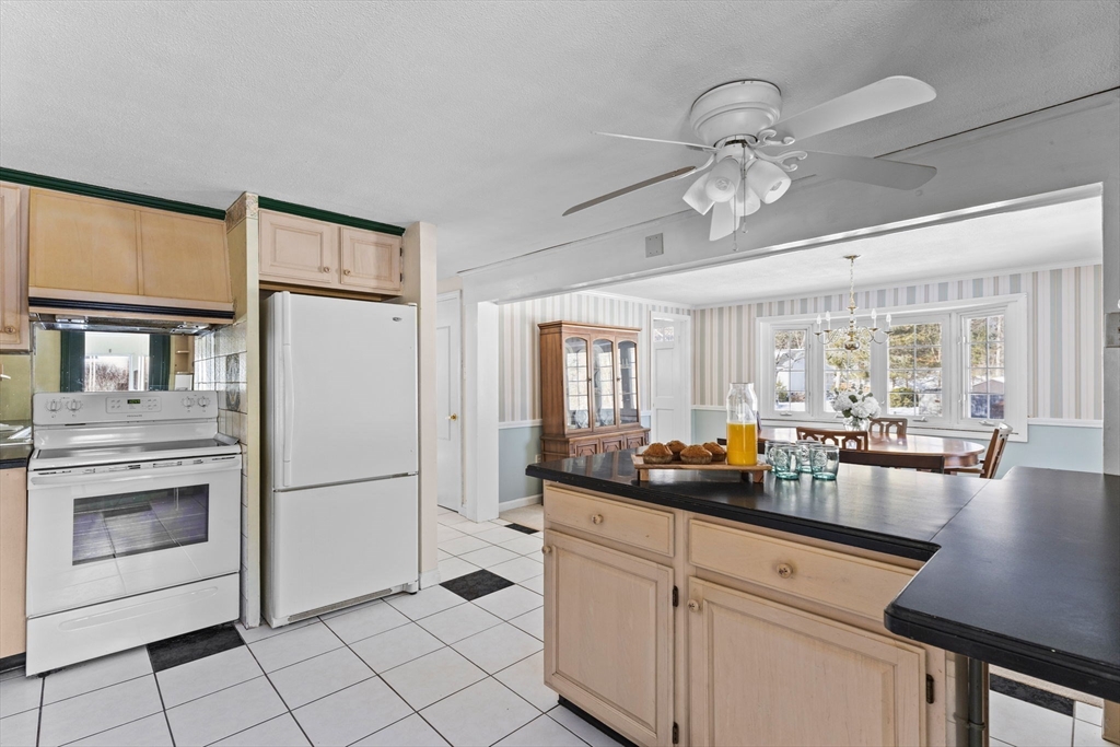 39 MacDonald Circle Walpole, MA 02081 - Photo 16 of 38 a kitchen with stainless steel appliances granite countertop a refrigerator and a sink