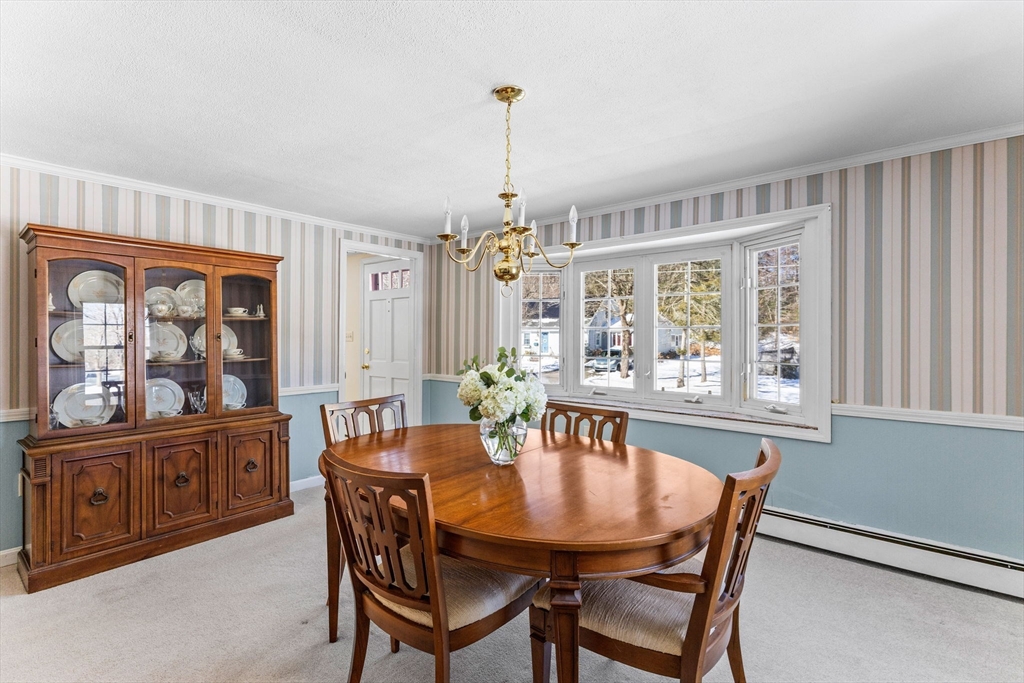 39 MacDonald Circle Walpole, MA 02081 - Photo 19 of 38 a dining room with furniture a chandelier and wooden floor