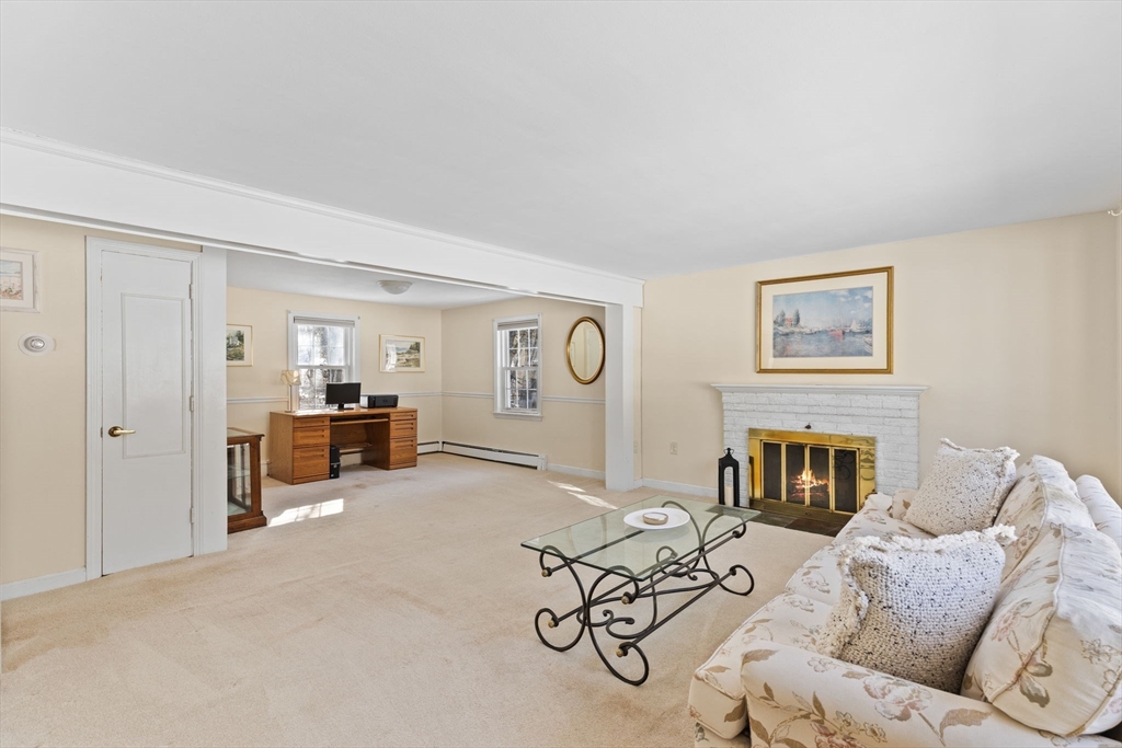 39 MacDonald Circle Walpole, MA 02081 - Photo 6 of 38 a living room with furniture and a fireplace