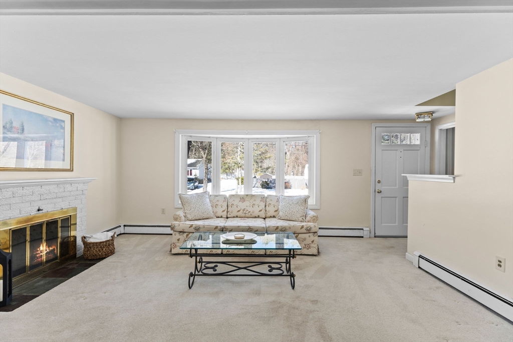 39 MacDonald Circle Walpole, MA 02081 - Photo 9 of 38 a living room with furniture and a fireplace
