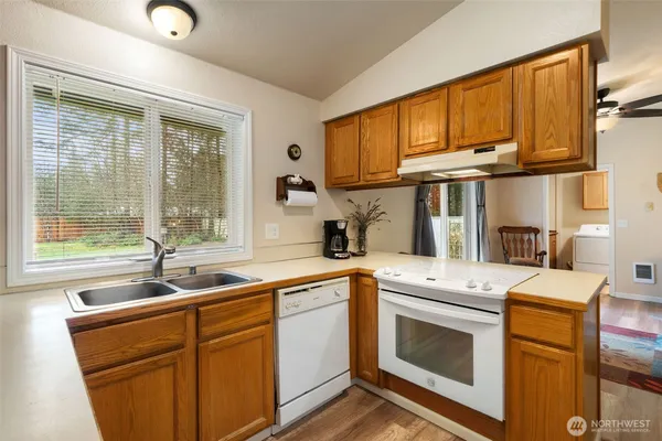 a kitchen with stainless steel appliances granite countertop a sink stove and cabinets
