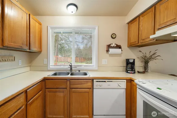 a kitchen with stainless steel appliances a sink a stove and a refrigerator