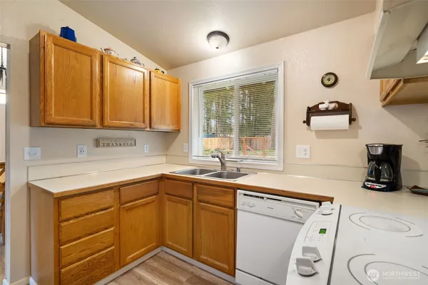 a kitchen with a sink stove and cabinets