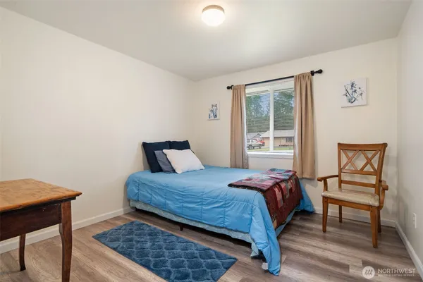 a bedroom with a bed and a tv on the dresser