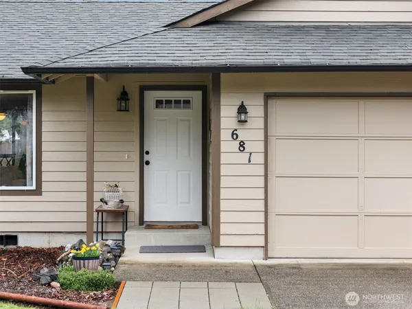 a balcony with potted plants and wooden floor