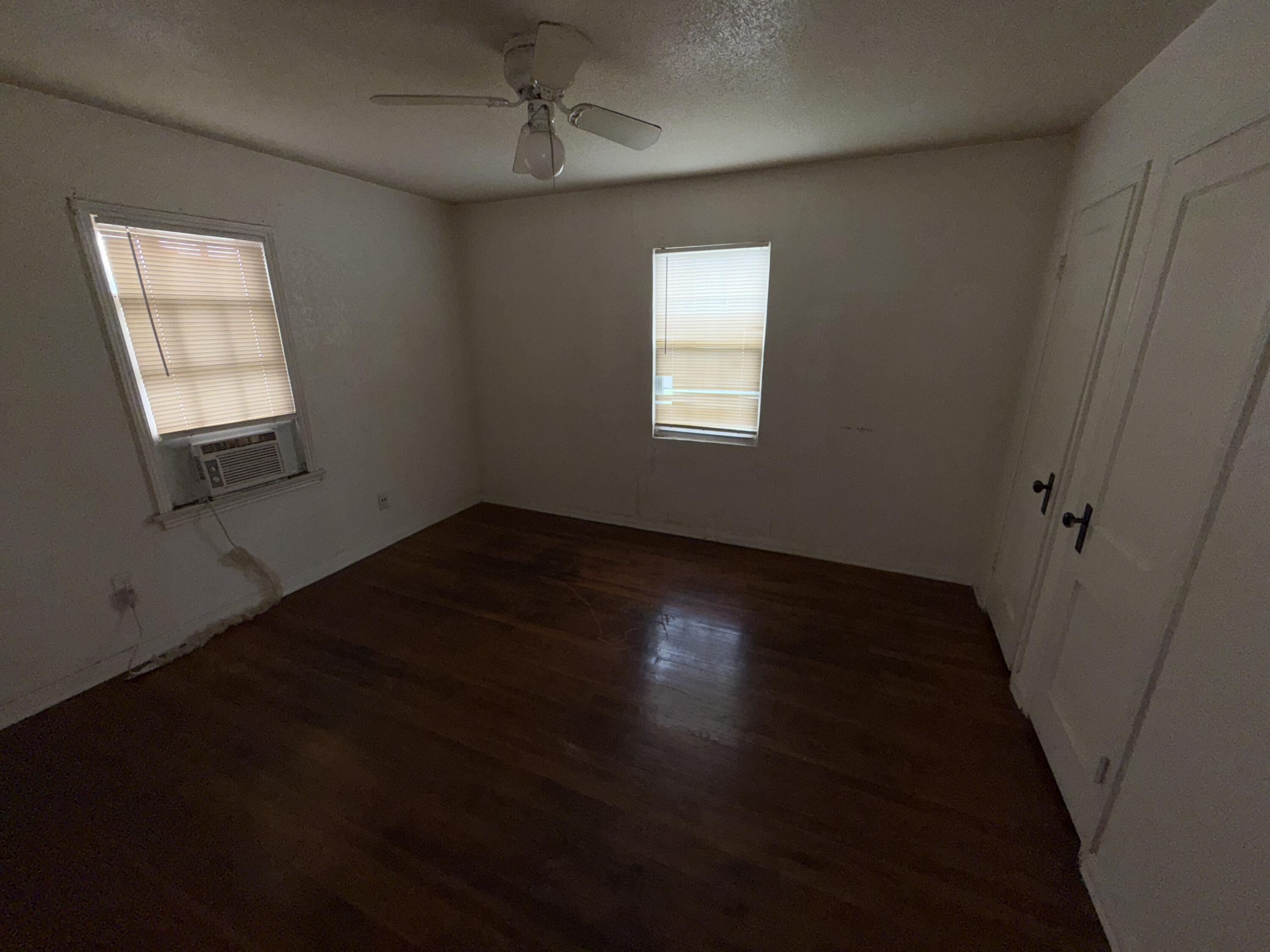 2416 31st Street Lubbock, TX 79411 - Photo 5 of 6 a view of an empty room with wooden floor and a window