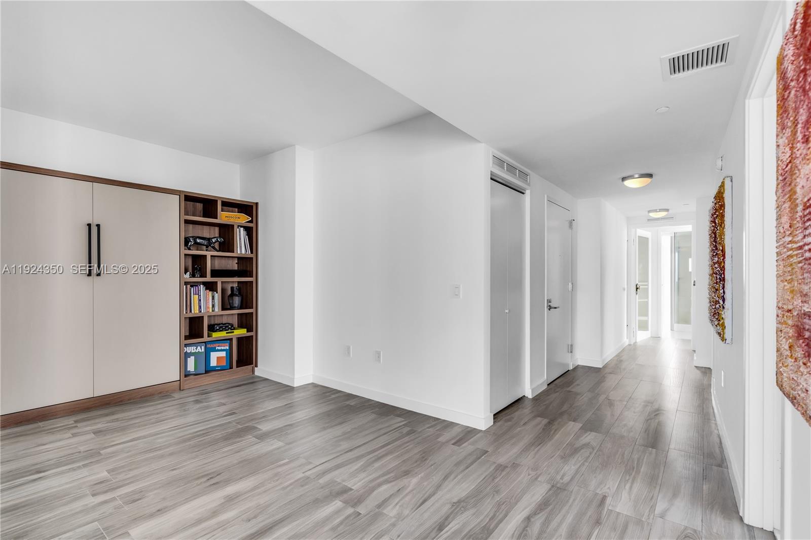 460 Northeast 28th Street, Unit 3601 Miami, FL 33137 - Photo 7 of 24 a view of a big room with wooden floor and closet