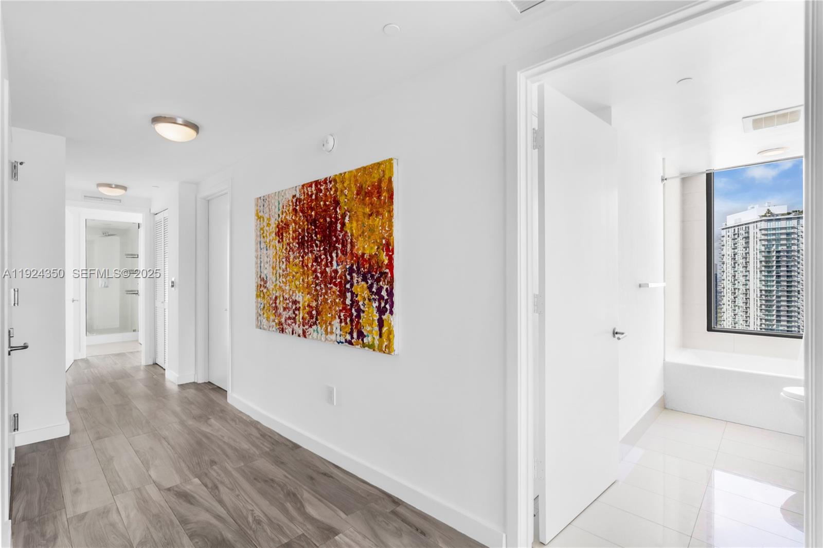 460 Northeast 28th Street, Unit 3601 Miami, FL 33137 - Photo 8 of 24 a view of a hallway with wooden floor and a living room