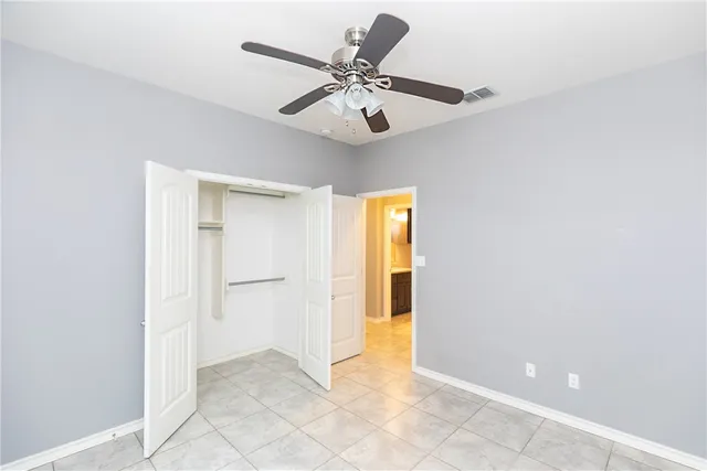 a view of an empty room with a ceiling fan