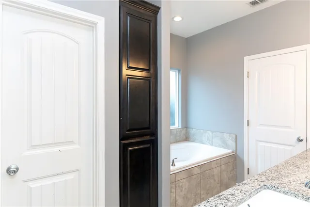 a bathroom with a tub and shower
