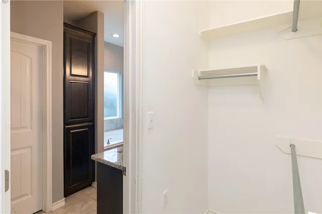 a bathroom with a granite countertop sink a mirror and a shower
