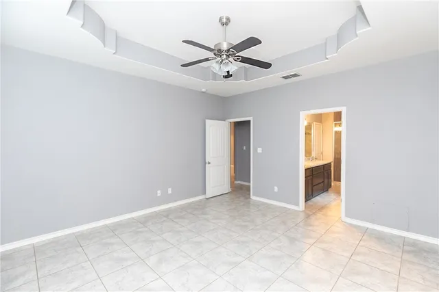 a view of an empty room with a ceiling fan