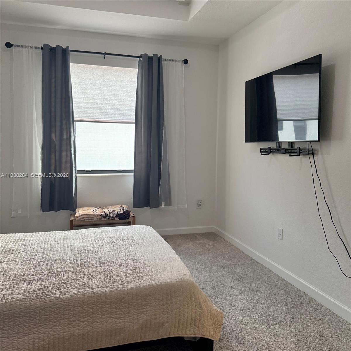 23049 Southwest 129th Place Miami, FL 33177 - Photo 17 of 29 a bedroom with a bed and a flat screen tv