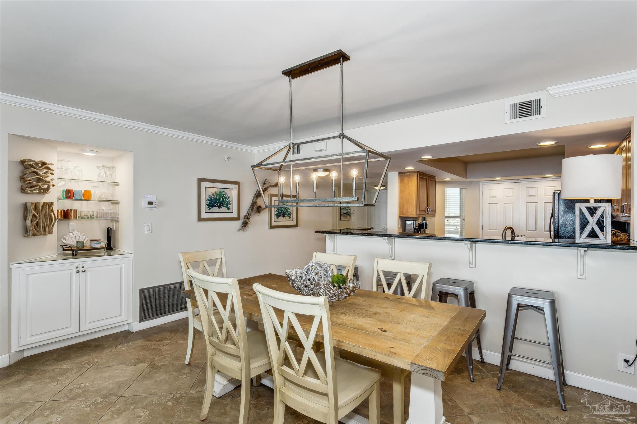 16285 Perdido Key Drive, Unit 625 Perdido Key, FL 32507 - Photo 13 of 49 a view of a dining room with furniture and chandelier