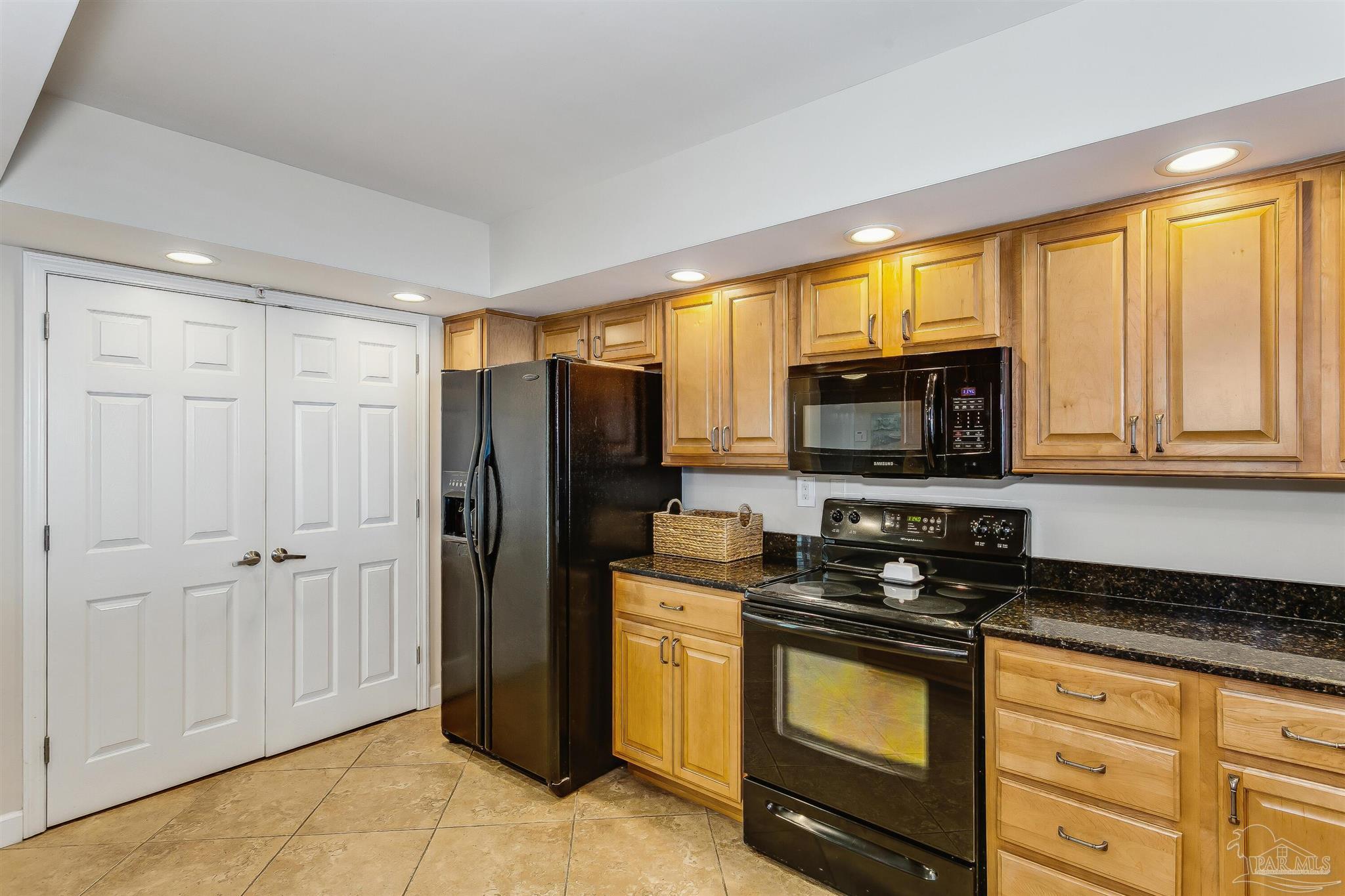 16285 Perdido Key Drive, Unit 625 Perdido Key, FL 32507 - Photo 17 of 49 a kitchen with granite countertop a refrigerator stove and microwave