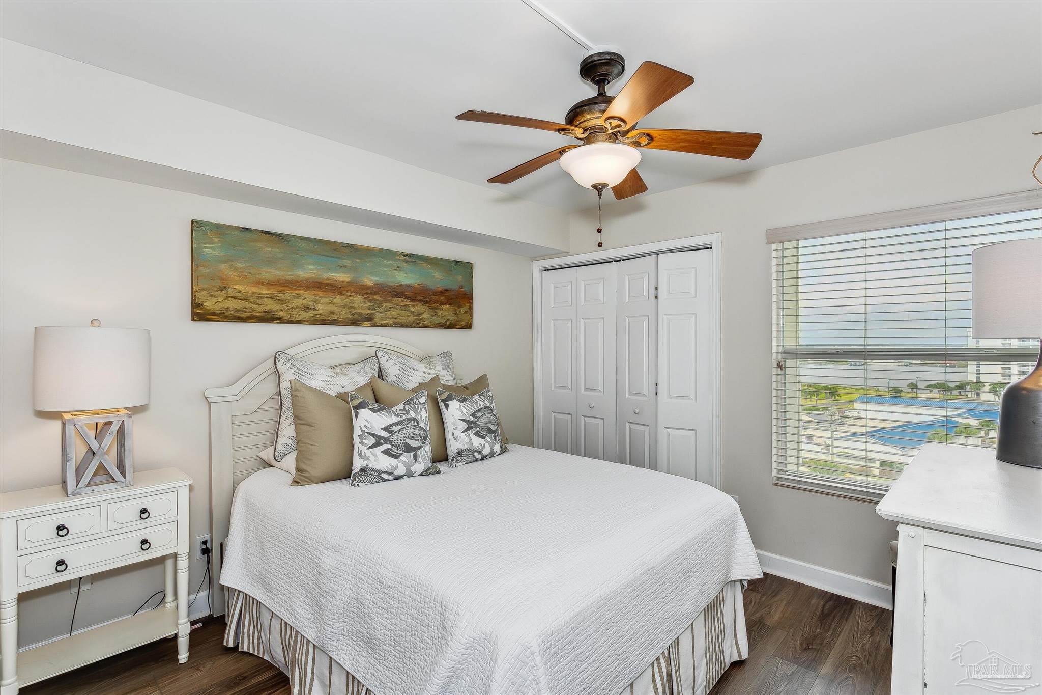 16285 Perdido Key Drive, Unit 625 Perdido Key, FL 32507 - Photo 24 of 49 a bedroom with a bed and a chandelier