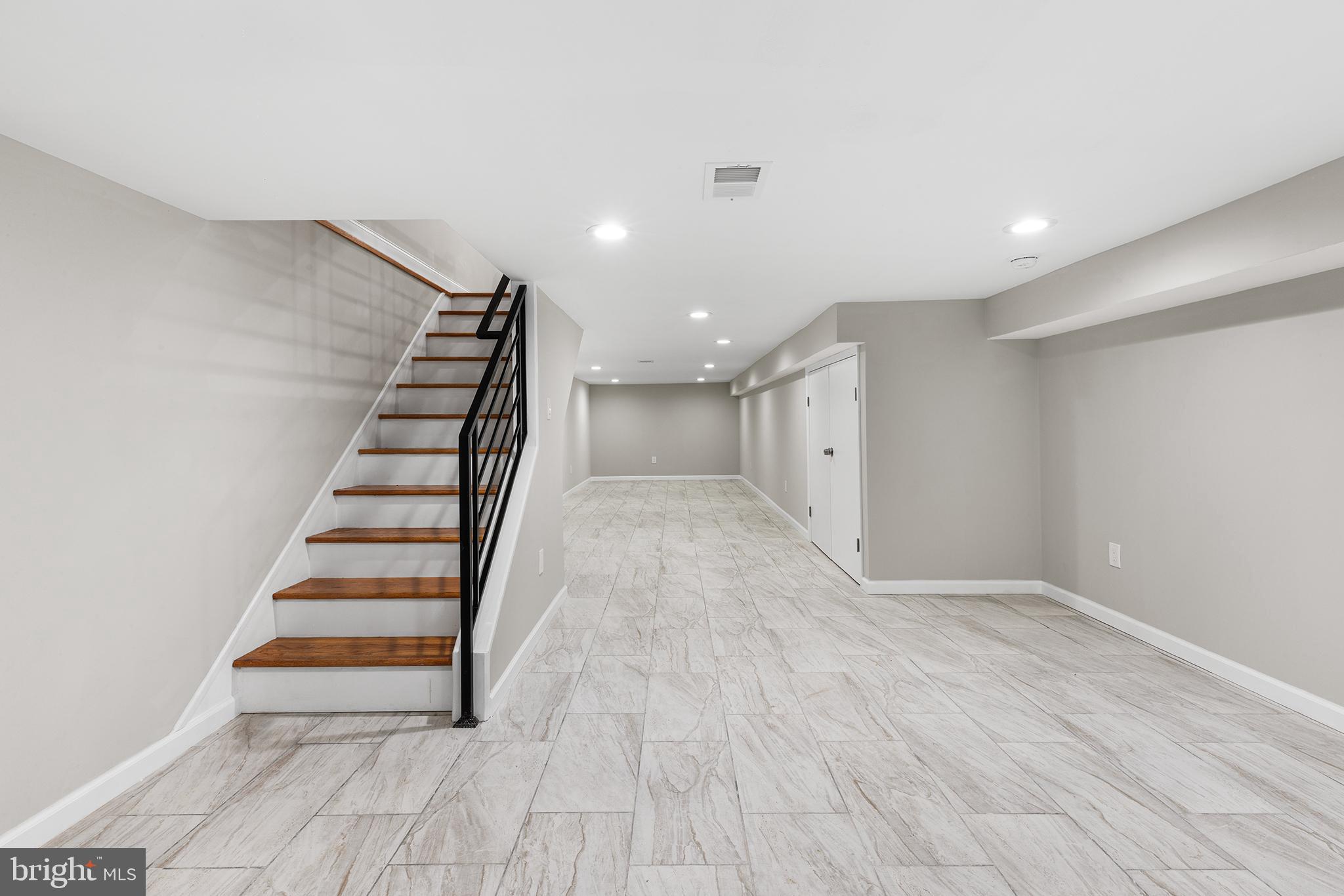 2236 Tasker Street Philadelphia, PA 19145 - Photo 12 of 26 wooden floor in an empty room with stairs