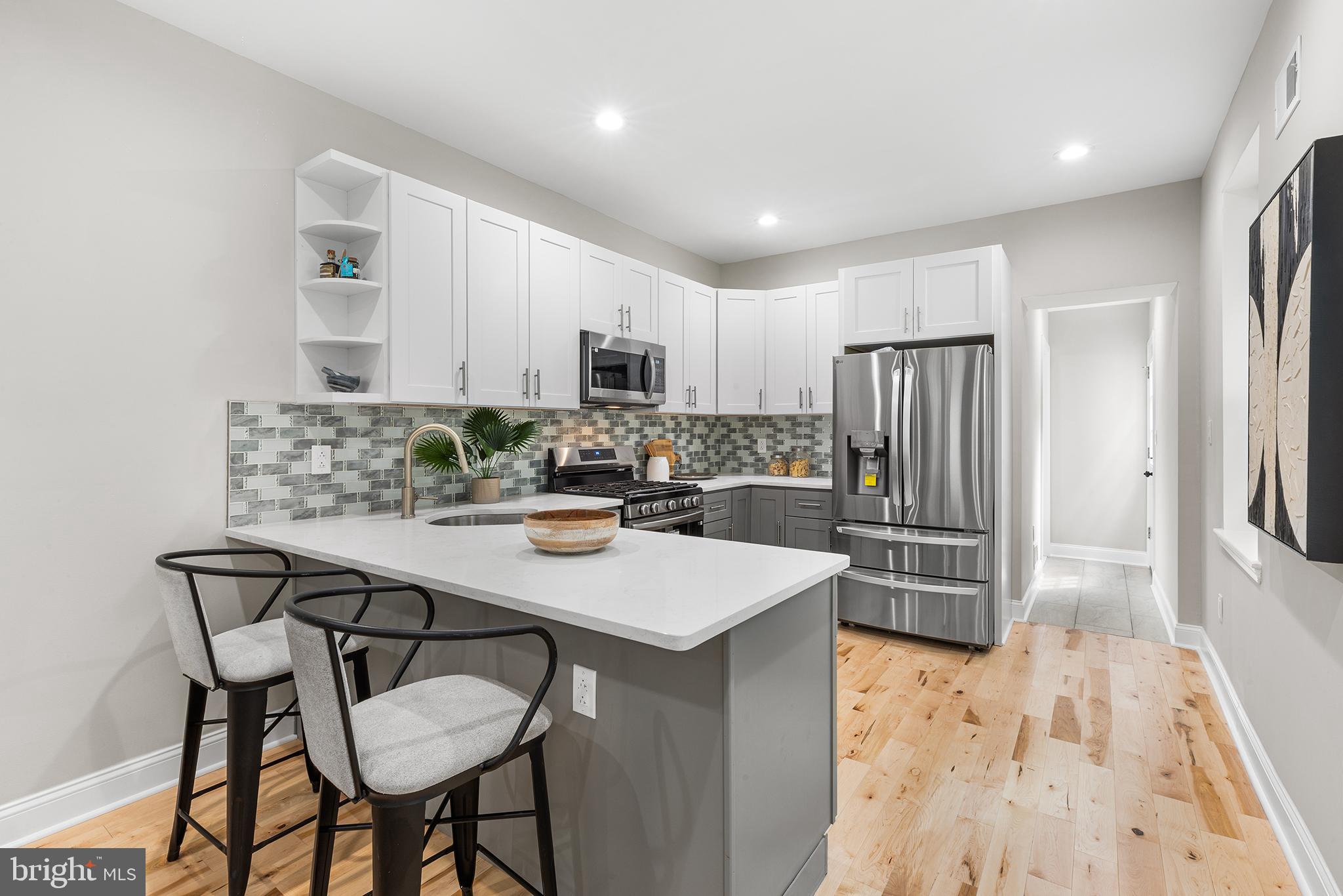 2236 Tasker Street Philadelphia, PA 19145 - Photo 7 of 26 a kitchen with stainless steel appliances a refrigerator and a stove top oven