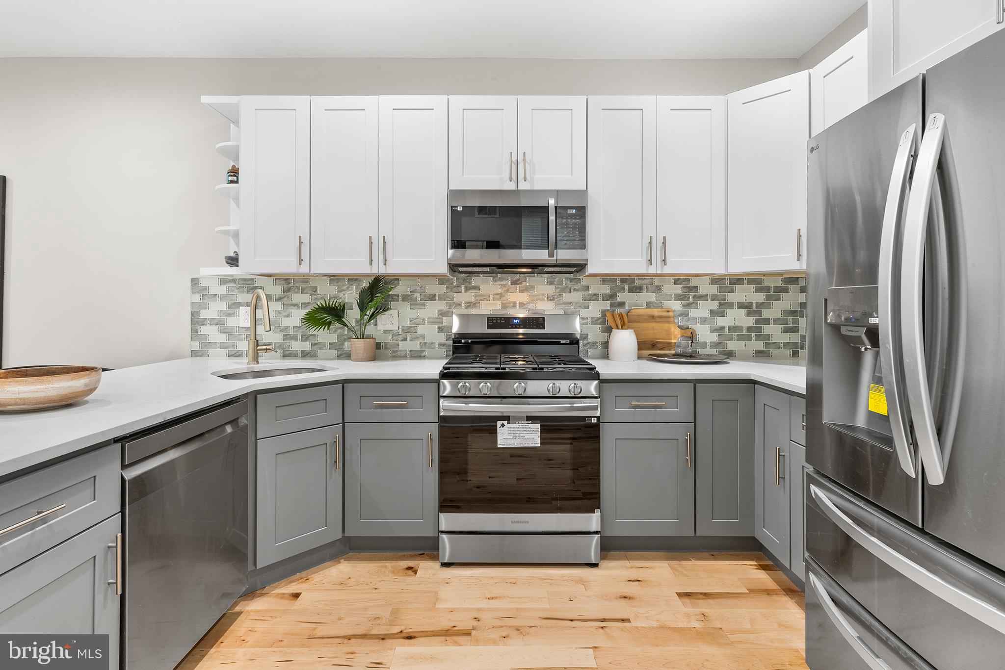 2236 Tasker Street Philadelphia, PA 19145 - Photo 9 of 26 a kitchen with stainless steel appliances granite countertop a stove a refrigerator and a sink