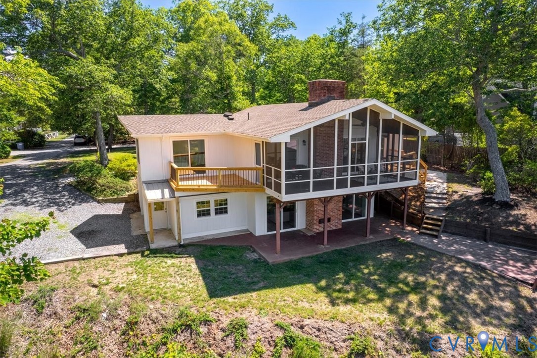 483 Mechams Cove Road Topping, VA 23169 - Photo 47 of 57 Rear exterior featuring a screened porch, a brick