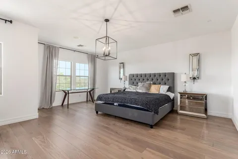a spacious bedroom with a bed and a table in it