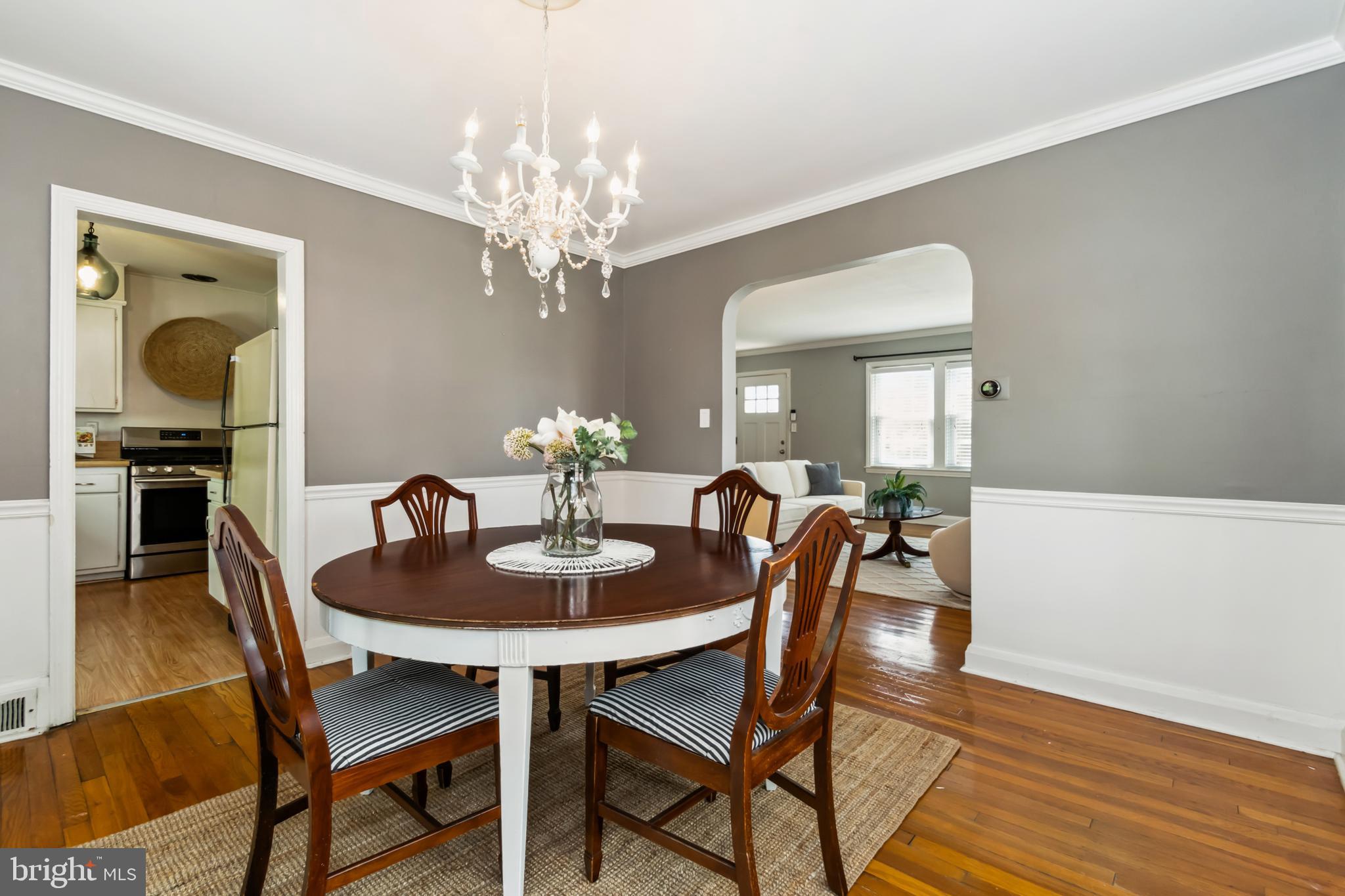 1848 Loch Shiel Road Towson, MD 21286 - Photo 8 of 25 a dining room with furniture a chandelier and wooden floor