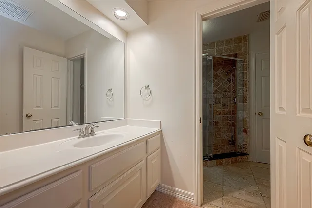 a large kitchen with sink and refrigerator