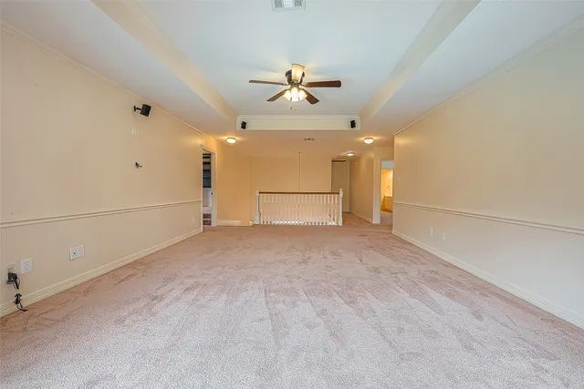 a view of house with a big yard and large trees