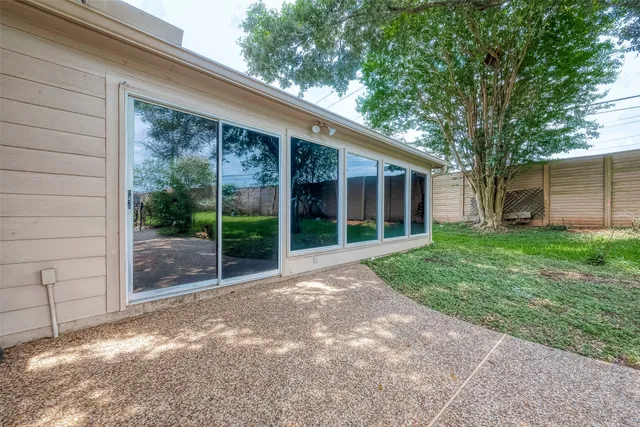 a view of a backyard with swimming pool