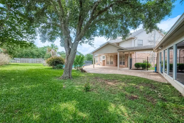 a view of a house with a yard and porch