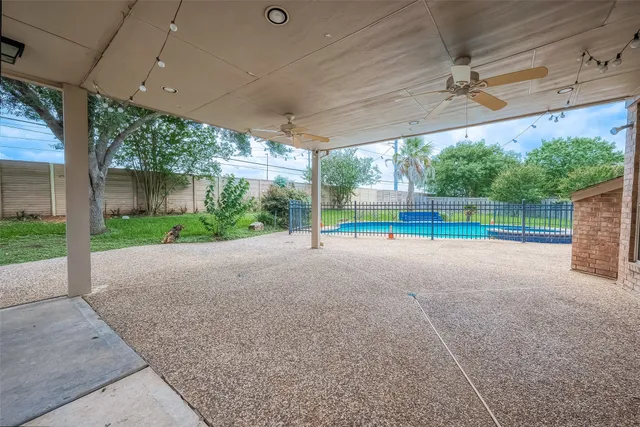 a view of a backyard with swimming pool
