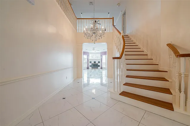 a view of a livingroom with wooden floor and a kitchen space
