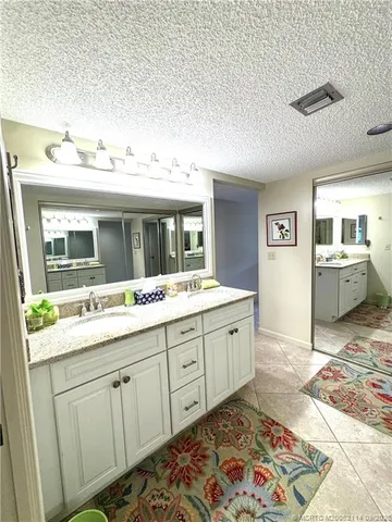 a spacious bathroom with a sink and mirror