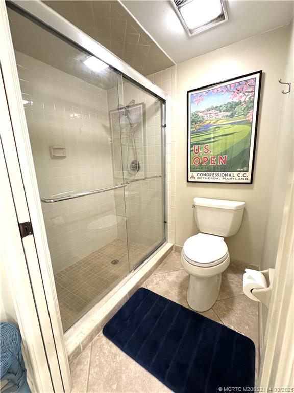 5172 Southeast Club Way, Unit 109 Stuart, FL 34997 - Photo 12 of 18 a bathroom with a toilet a sink and shower