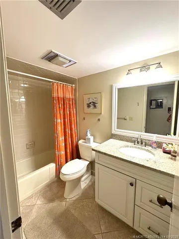 a spacious bathroom with a sink a toilet a mirror a bathtub and shower