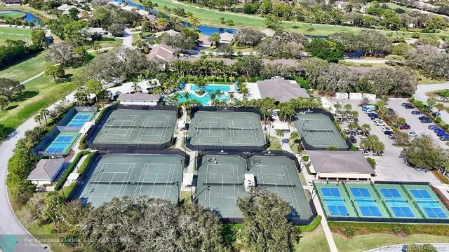 an aerial view of a residential houses with outdoor space