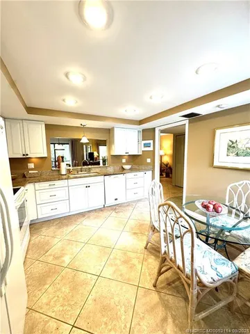 a large kitchen with granite countertop a large stove a sink and cabinets